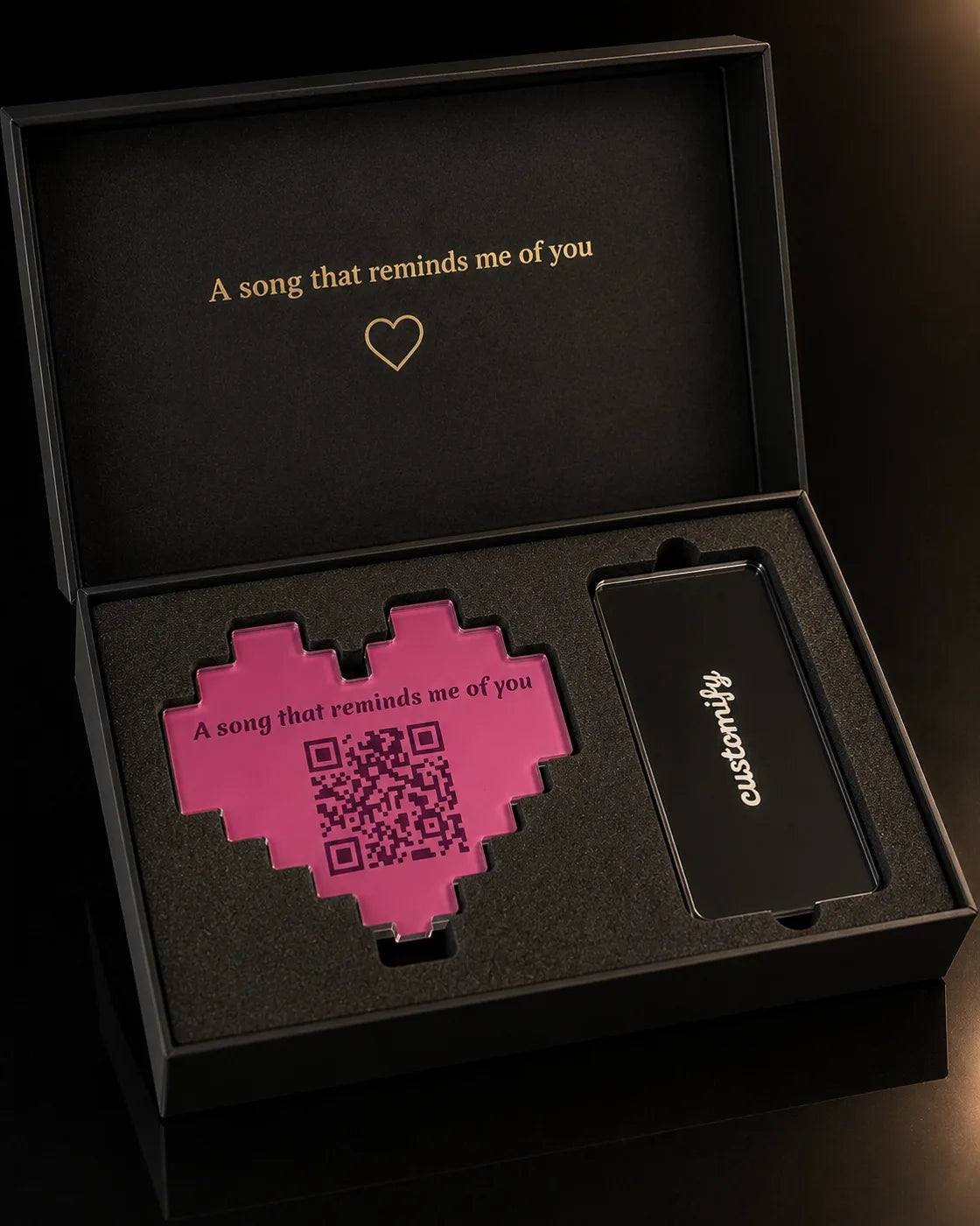 The luxury gift box — velvet-lined, gold-engraved lid, both pieces nested in foam